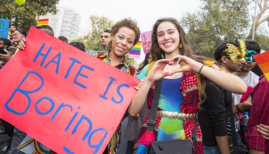 istock-499487582_870x500.jpg Pride parade with sign 'Hate is boring'